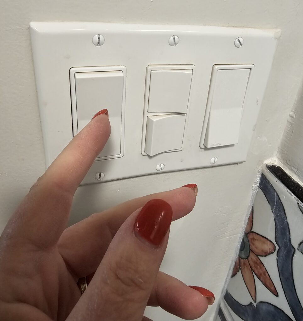 Dimmer switch on a bathroom wall